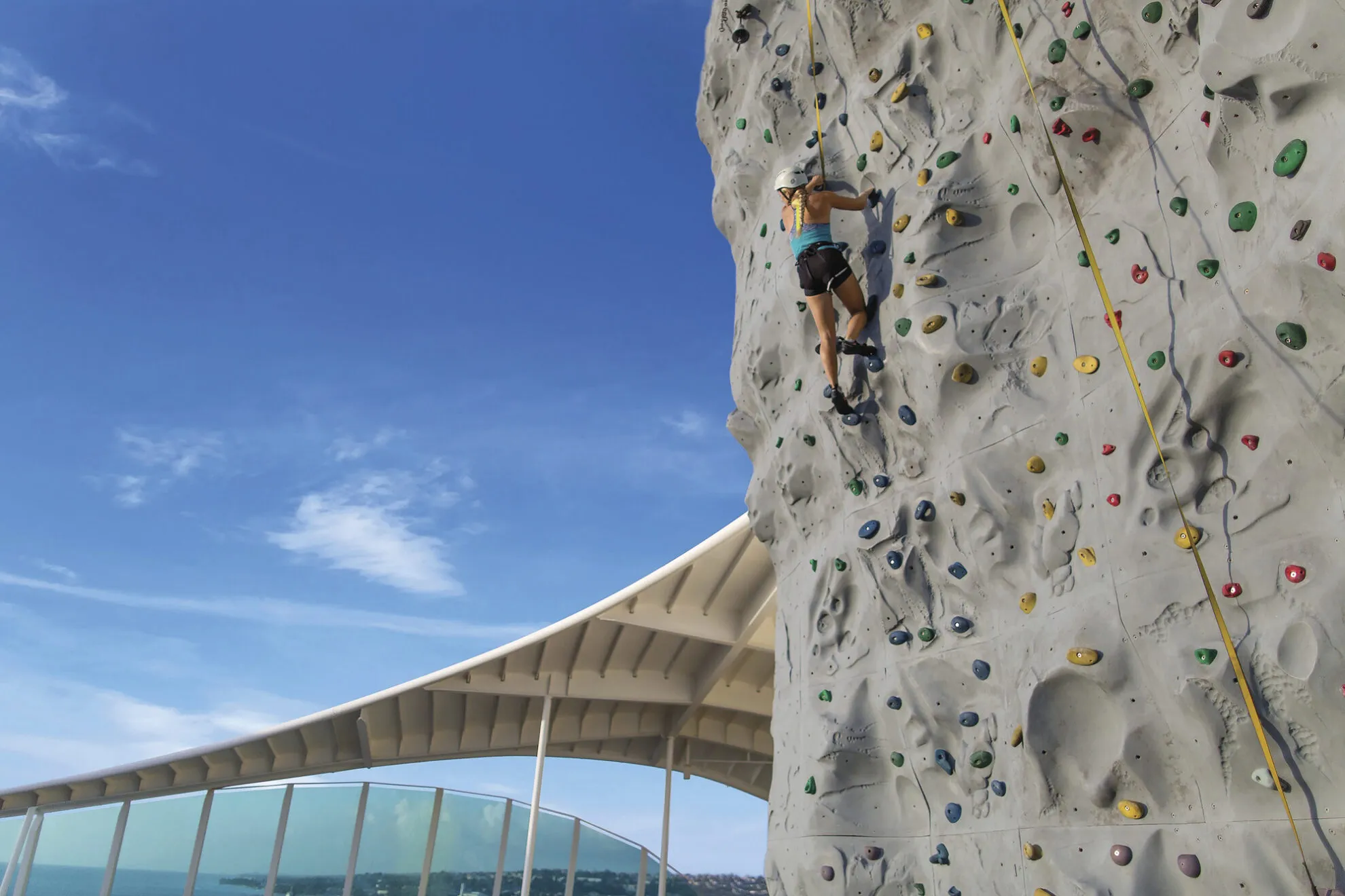 2491267-2417843-V1-P0 GoH, Dan Worden, influencers, AD, Adventure of the Seas, young woman climbing rock wall, fun, exercise, effort, daring,