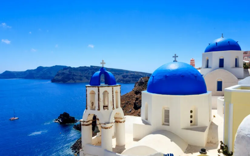Panoramic shot of the Blue domed church at Oia Santorini Greece Europe