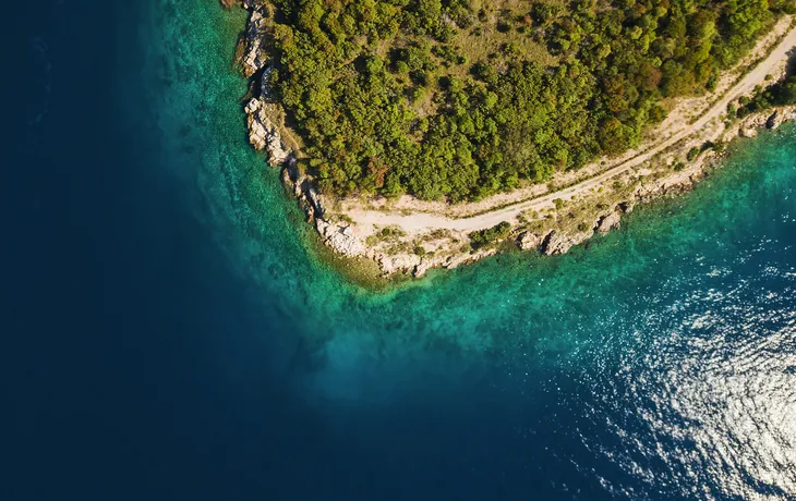 Luftaufnahme des kristallklaren Wassers vor der Küste der kroatischem Insel Krk