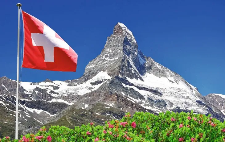 Beautiful mountain Matterhorn with Swiss flag - Swiss Alps