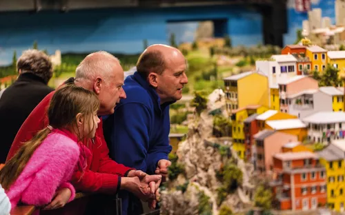 Personen betrachten ein Miniaturmodell einer Stadt.